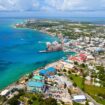 Grand Cayman's stunning coastline extends far beyond George Town's busy harbor—and the best beaches are waiting just down the road. Photo by Blue Sky from Getty Images via Canva