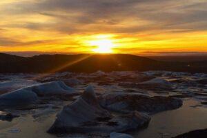 Sunset over a glacial lake in Iceland - all taken in from the cosy comforts of our campervan. Photo by Hannah