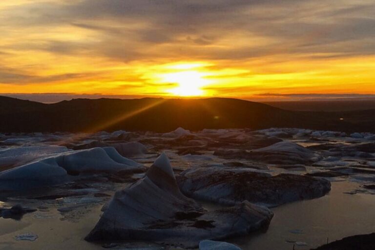 Sunset over a glacial lake in Iceland - all taken in from the cosy comforts of our campervan. Photo by Hannah