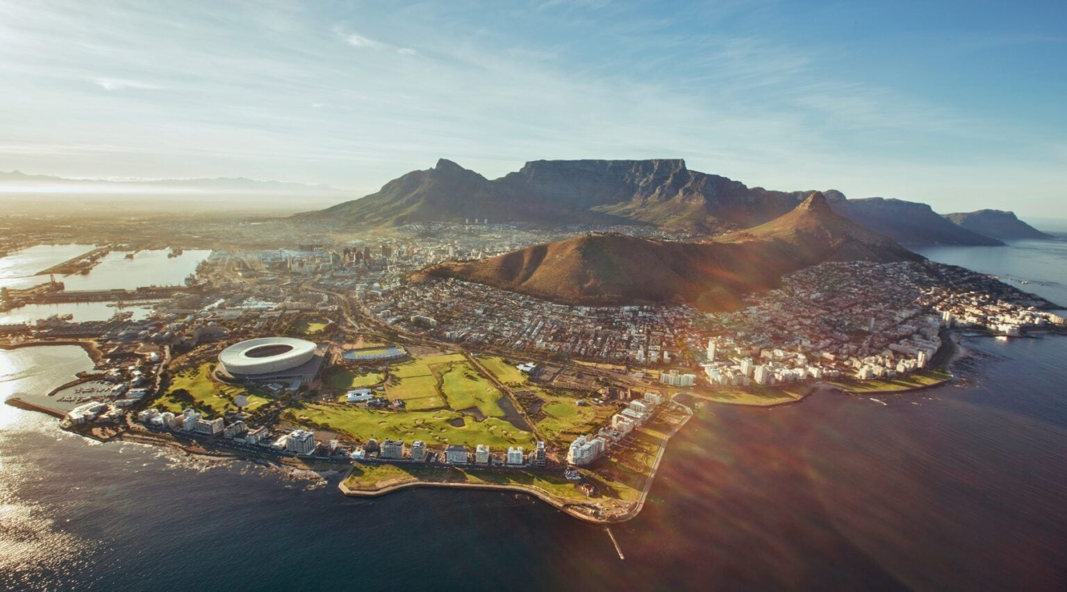 Table Mountain rises over Cape Town's Atlantic coastline. Photo by Jacob Lund via Canva
