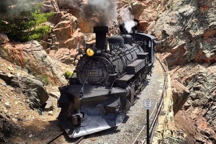 Steam train coming out of tunnel