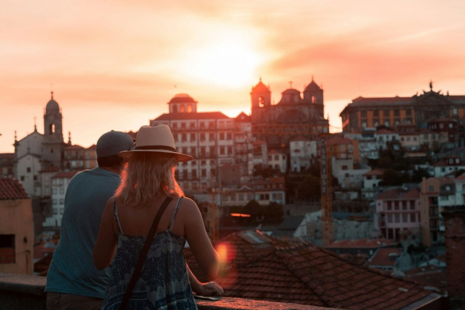 A couple watching the sunset in Porto, Portugal