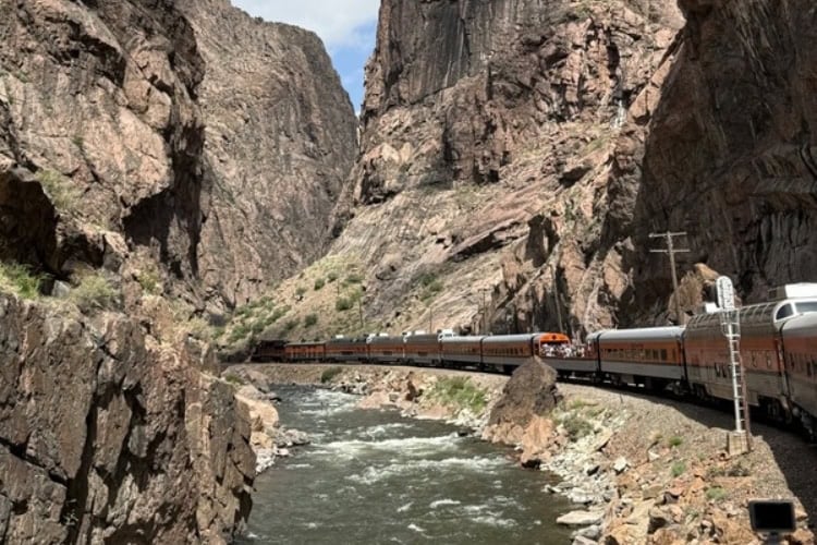 Train going under Royal Gorge Bridge