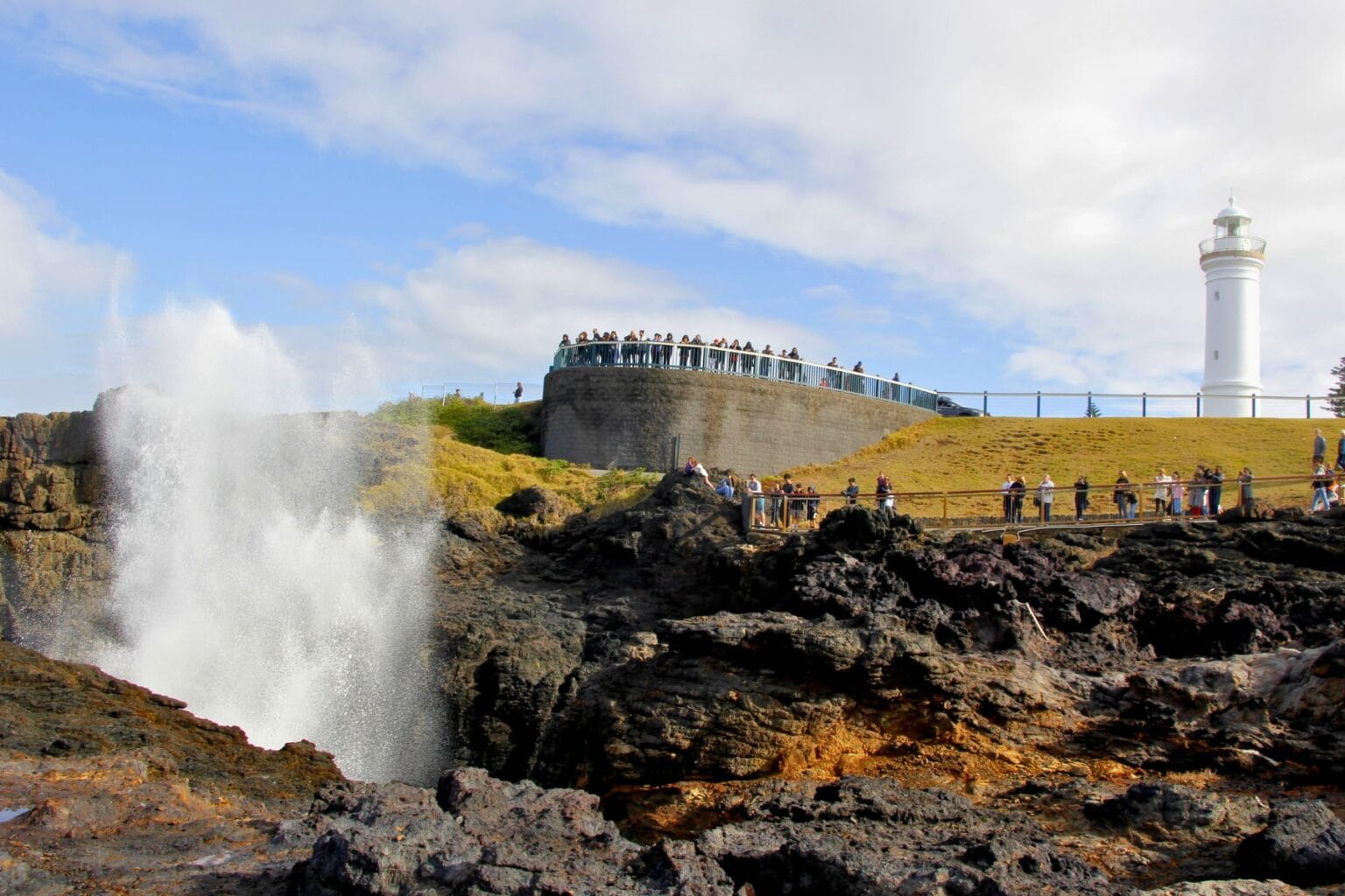 Visitors gather to watch the famous Kiama Blowhole as ocean swells push water through the rocky coastline. Photo by Ayan Adak