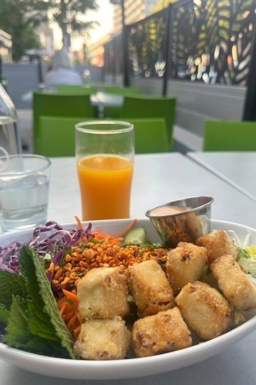 Sitting outside with my rainbow bowl at Pure Kitchen. Photo by Teresa Bergen