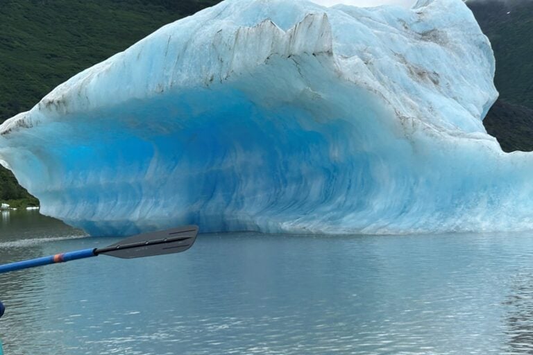 Spencer Glacier calving with an oar in the foreground. Photo by Marcia McGreevy Lewis