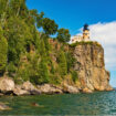 Split Rock Lighthouse sits atop a 130-foot cliff above Lake Superior. Photo by northwoodsphoto from Getty Images via Canva