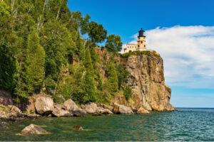 Split Rock Lighthouse sits atop a 130-foot cliff above Lake Superior. Photo by northwoodsphoto from Getty Images via Canva