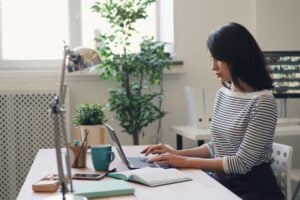 Young woman working with a laptop. Photo by Vitaly Gariev, Unsplash