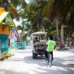 A man rides a bike in Caye Caulker in Belize.