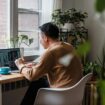 A man sitting on a chair while working on his laptop. Photo by Annushka Ahuja, Pexels