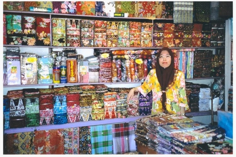 Woman sells her beautiful textiles. Photo by Jane Cassie