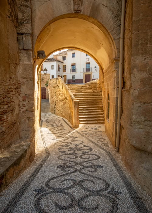 Narrow winding street with Moorish influence outside of La Iglesia de La Encarnaci&oacute;n, Alhama de Granada, Spain. 