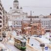 A tram navigates snow-lined streets beneath Helsinki's neoclassical cityscape. Photo by Said Aqqa, Unsplash