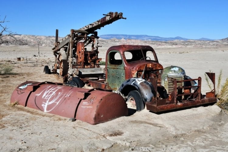 The old truck and rig ruins create contrasting colors at Water Well Oasis on the Cathedral Valley Loop. Photo by Tab Hauser