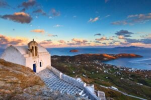A chapel perched above Serifos's port town of Livadi. Photo by milangonda from Getty Images via Canva