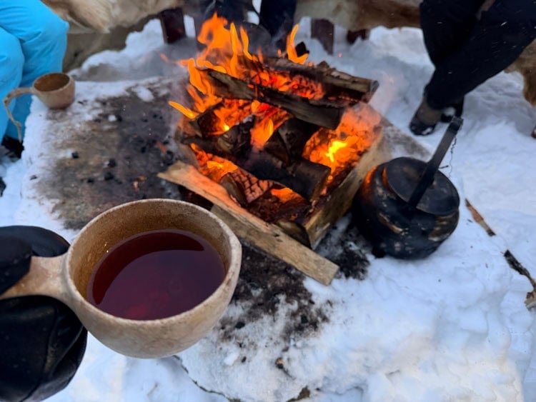 Hot lingonberry juice warmed over an open fire. Photo by Janna Graber