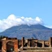 Mount Vesuvius dominates the Pompeii skyline. The Temple of Jupiter lies in the foreground. Photo by Frank Hosek