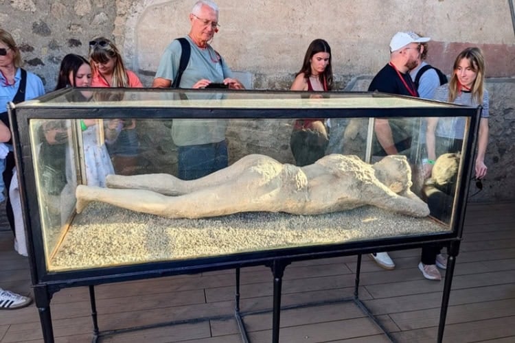 The plaster cast of a young female from Pompeii. Most inhabitants died asphyxiated by poison gases and were buried by volcanic ash. This cast is one of over 100 created by pouring liquid plaster into cavities left by decomposed bodies. Photo by Frank Hosek