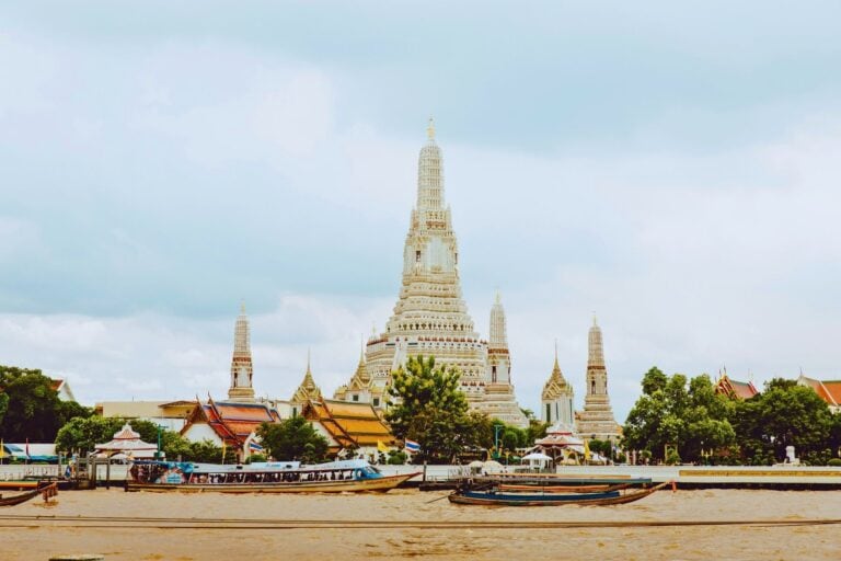 Boats in front of a temple in Bangkok, Thailand. Photo by Evan Krause, Unsplash