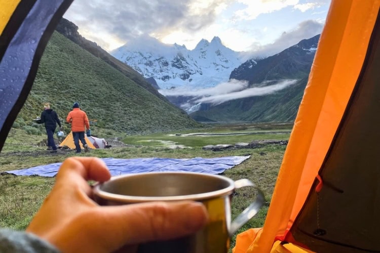 Warm tea while camping by Lake Jahuacocha with views of Cordillera Huayhuash. Photo by Chana Widawski.