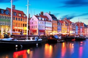 Colorful Nyhavn in Copenhagen by night. Image by scanrail from Getty Images Pro via Canva