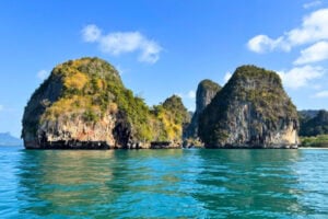 Limestone karsts rise dramatically from the sea, towering around us like ancient sculptures. Photo by Brent Cassie