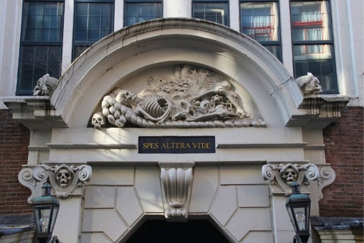 The reclining skeletal figure above the doorway of St. Olof&rsquo;s Chapel, the oldest in Amsterdam and now an event venue. Photo courtesy of Mark Law