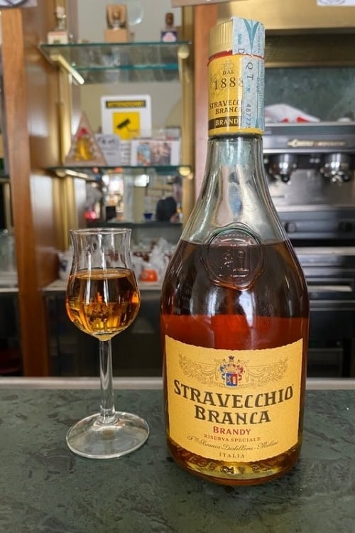 A quick stop at a street-side bar offers a respite from the day's walking a visitor will do. Italy has some of the best brandy in the world. Photo by Avery Chmelewski