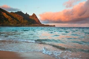 Tunnels Beach on the island of Kauai at sunset. Photo by Kamchatka via Canva