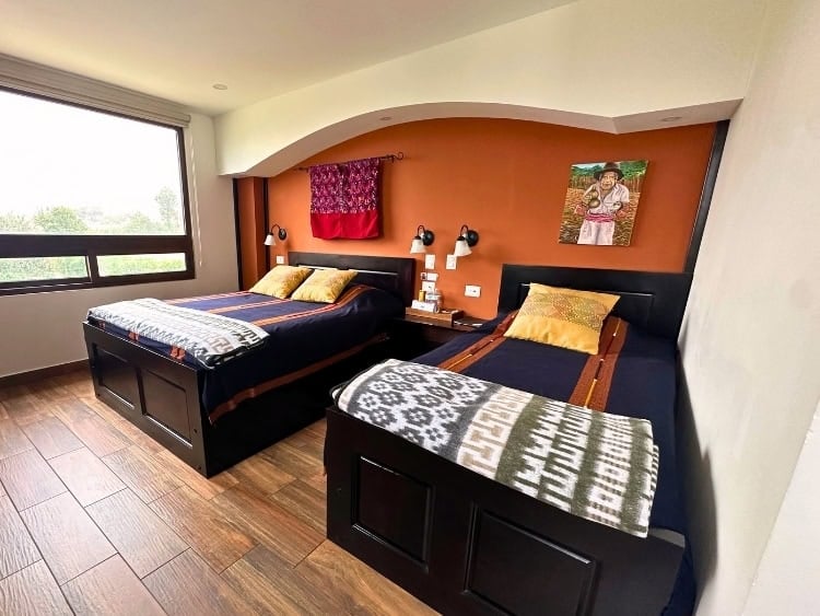 A cozy room at the Eco Guest House at San Mart&iacute;n, featuring handwoven blankets made by local Mam artisans. Photo by Isabella Miller