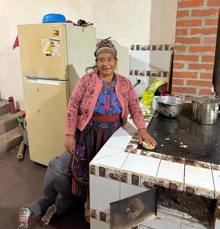 A local Mam woman shares the tradition of handmade tortillas with visiting volunteers. Photo by Isabella Miller