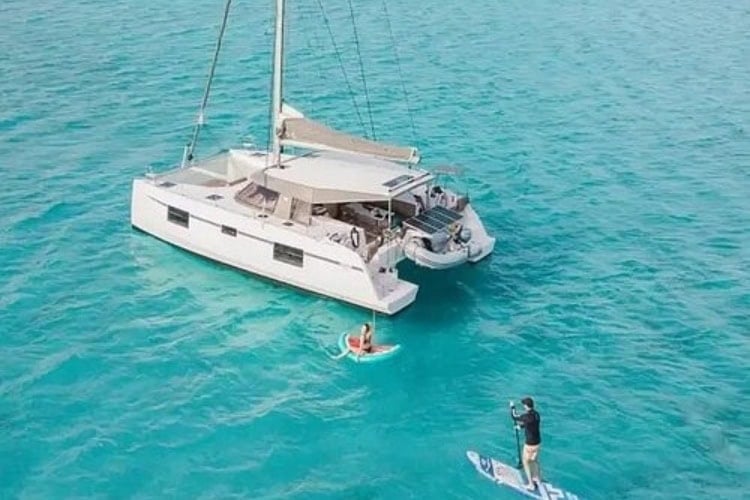 Catamaran sailing in the turquoise waters of the Cyclades. Photo courtesy of the author