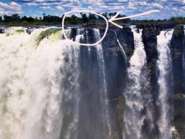 Arrow pointing to the edge of falls known as Devil's Pool. Photo by Tab Hauser