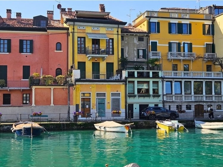 Boats lining the tranquil waters of the Mincio Canal in Peschiera del Garda. Photo by Zuzana Zimmermannova