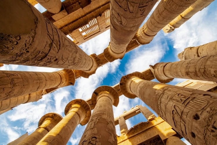 Karnak Hypostyle Hall columns and clouds in the Temple at Luxor, Thebes, Luxor, Egypt. Photo by Calin Stan, Unsplash