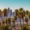A scenic view of downtown Los Angeles, California, with iconic palm trees in the foreground, capturing the vibrant essence of the city. Photo by Getty Images, Unsplash