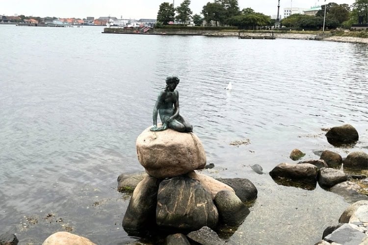 The Little Mermaid sitting on a rock at Langelinie Pier in Copenhagen, Denmark. Photo by Maureen C. Bruschi