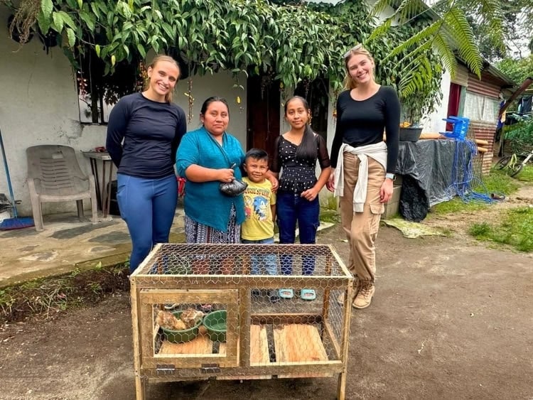 The author, Isabella and her friend Lauryn deliver a chicken coop for a family in the communities surrounding San Mart&iacute;n Chiquito. Photo by Maria Julia Donis Barillas