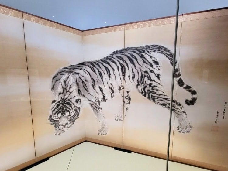 A large tiger nearly jumps off the screen in the Suntory Museum. Photo by Alexander Goodman