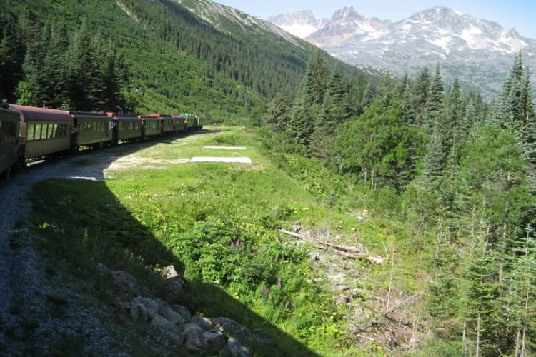 White Pass Railway journey with dramatic mountain views. Photo by Brent Cassie