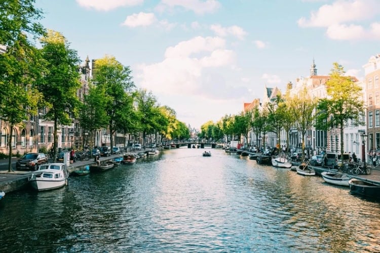 Body of water under white sky in Amsterdam, Netherlands. Photo by Adrien Olichon, Unsplash