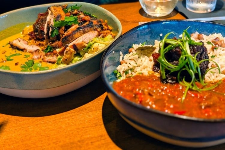 Chopnblok's menu is built around rice bowls that integrate African and American Southern influences, like the Smokey Jollof Jambalaya in the front. Photo by Craig Stoltz