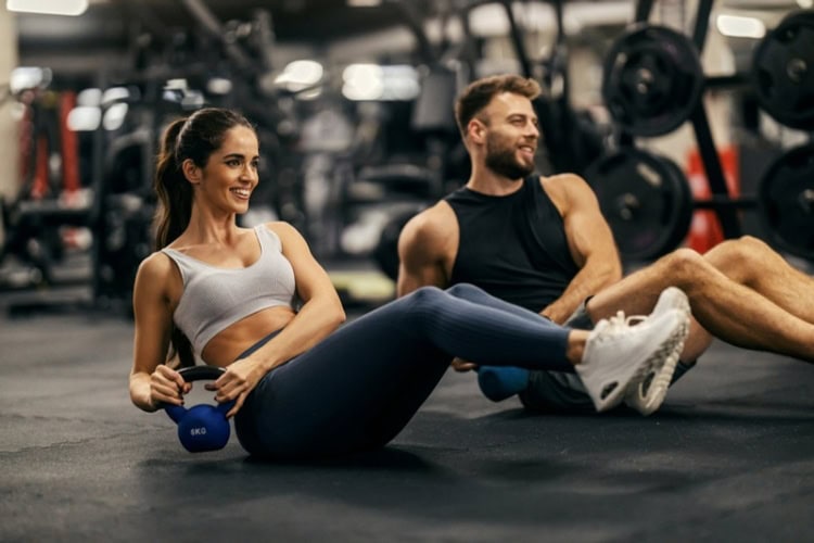 Fit sporty couple in a gym. Photo by Getty Images, Unsplash