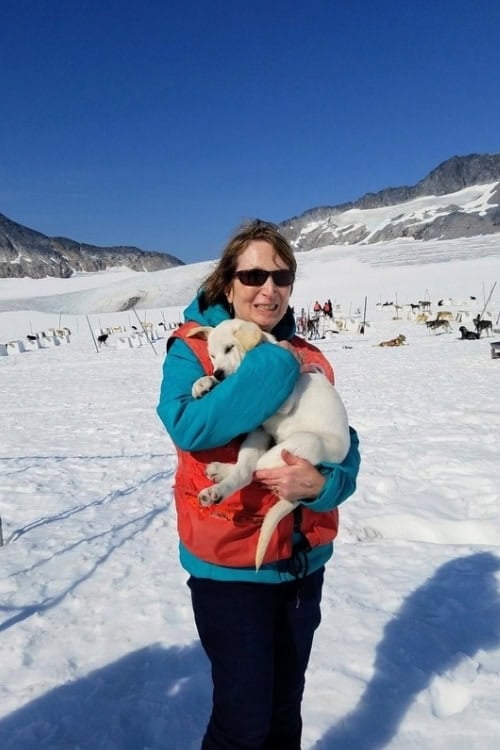 Hugging a future sled dog. Photo courtesy of Dorothy Maillet