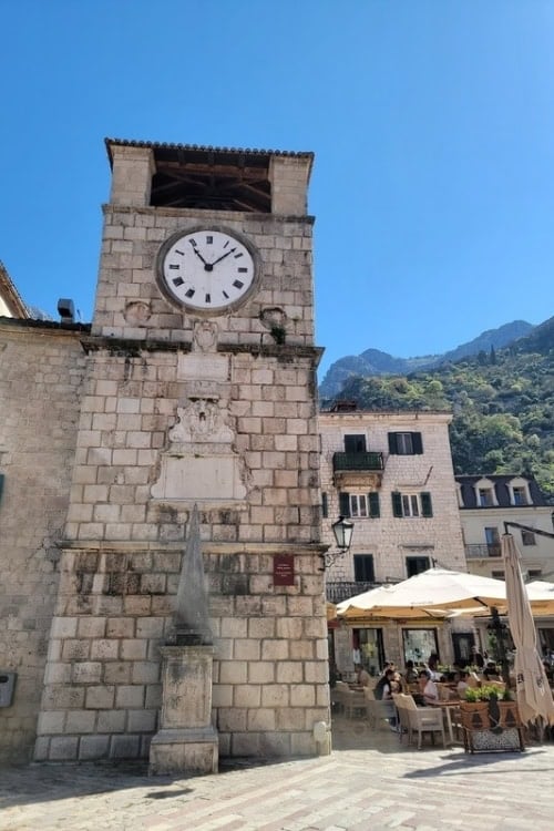 Kotor's leaning clock tower with the pillar of shame. Photo by Eric D. Goodman