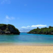 Lush shoreline and rock islets as seen from Ikei Beach in Okinawa, Japan. Photo by Liv Headley