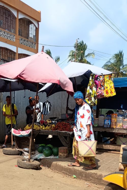 Vendors hawked overripe bananas to women shoppers wearing colorful turban head wraps