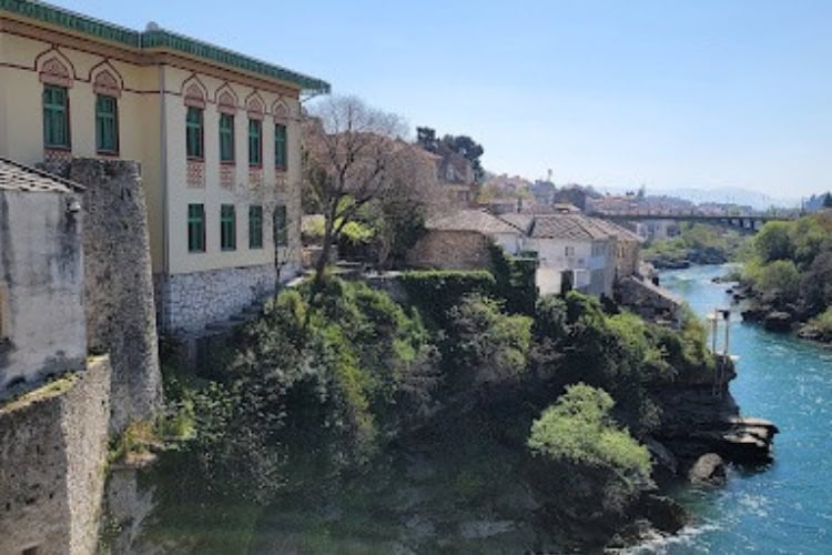 Mostar's buildings overlooking Neretva River. Photo by Eric D. Goodman