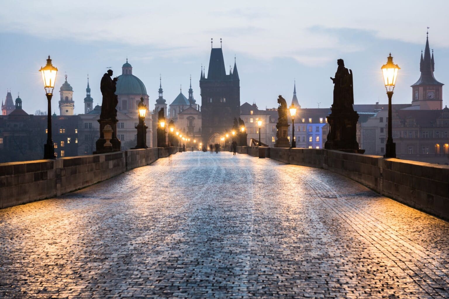 The famous Charles Bridge in Prague is still beautiful in the rain. Image by tichr from Getty Images via Canva